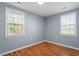 Well lit bedroom with wood flooring and neutral walls at 2041 Grassy Creek Virgilina Rd, Oxford, NC 27565