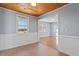 Dining area with wood ceiling, wood floors, and white wainscoting at 2041 Grassy Creek Virgilina Rd, Oxford, NC 27565