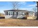 Charming single-story home with gray siding, black shutters, and a cozy front porch under a blue sky at 2041 Grassy Creek Virgilina Rd, Oxford, NC 27565