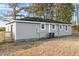 Gray house exterior with a large backyard at 2041 Grassy Creek Virgilina Rd, Oxford, NC 27565