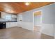 Updated kitchen with white cabinets, black appliances, and tin backsplash at 2041 Grassy Creek Virgilina Rd, Oxford, NC 27565