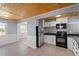 Modern kitchen with white cabinets, black appliances, and tin backsplash at 2041 Grassy Creek Virgilina Rd, Oxford, NC 27565