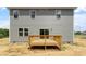 Home exterior with wooden deck and gray siding under a clear sky at 211 Grove Township Way, Angier, NC 27501