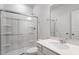 Bathroom featuring a glass-enclosed shower and a vanity with a quartz countertop at 211 Grove Township Way, Angier, NC 27501