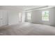 Bright bedroom features plush carpet, tray ceilings, and multiple windows, creating a relaxing retreat at 211 Grove Township Way, Angier, NC 27501