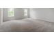 Spacious bedroom offers neutral carpet and multiple windows, creating a serene atmosphere at 211 Grove Township Way, Angier, NC 27501