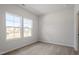 Bright bedroom with neutral carpet, two large windows, and white walls at 211 Grove Township Way, Angier, NC 27501