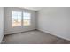 Bright bedroom with plush carpet and double windows filling the room with light at 211 Grove Township Way, Angier, NC 27501