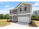 Charming two-story home with a two-car garage and landscaped front yard at 211 Grove Township Way, Angier, NC 27501