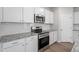 Kitchen with stainless steel appliances, granite counters, and white subway tile backsplash at 211 Grove Township Way, Angier, NC 27501