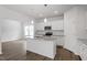 Modern kitchen featuring white cabinets, granite countertops and stainless appliances at 211 Grove Township Way, Angier, NC 27501