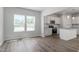 Open-concept kitchen boasts stainless appliances, granite countertops, and a large island with breakfast bar at 211 Grove Township Way, Angier, NC 27501