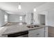 Kitchen island with granite countertops and a stainless steel dishwasher at 211 Grove Township Way, Angier, NC 27501