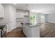 Kitchen island with granite countertops and stainless steel appliances in an open-concept layout at 211 Grove Township Way, Angier, NC 27501
