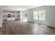 Expansive living area with wood-look flooring, connecting to the kitchen and outdoor patio at 211 Grove Township Way, Angier, NC 27501