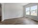 Bright living room features wood-look floors and two large windows providing ample natural light at 211 Grove Township Way, Angier, NC 27501