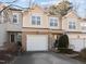 Attractive tan brick townhome with a 2-car garage at 2118 Stoney Spring Dr, Raleigh, NC 27610