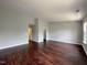 Large bedroom with dark wood floors, and access to bath and closet at 2221 Valley Edge Dr # 105, Raleigh, NC 27614