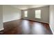 Spacious bedroom with dark wood flooring and two windows at 2221 Valley Edge Dr # 105, Raleigh, NC 27614
