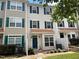 Three-story townhouse with a copper-colored roof and green shutters at 2221 Valley Edge Dr # 105, Raleigh, NC 27614