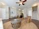 Open living space with hardwood floors, a ceiling fan, and a staircase at 2221 Valley Edge Dr # 105, Raleigh, NC 27614
