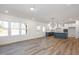 Open concept kitchen with blue island and white cabinets at 229 Beacon Dr, Pittsboro, NC 27312