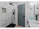 Clean bathroom with a walk-in shower and marble tile at 2513 Rochelle St, Durham, NC 27703