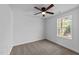 Spacious bedroom with carpet, large window, and ceiling fan at 2513 Rochelle St, Durham, NC 27703