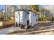 Two-story house with gray siding, a dark garage door, and a wooden deck at 2513 Rochelle St, Durham, NC 27703