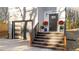Modern home entrance with dark door, wooden stairs, and landscaping at 2513 Rochelle St, Durham, NC 27703