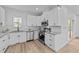 Bright kitchen with white cabinets, granite counters, and stainless steel appliances at 2513 Rochelle St, Durham, NC 27703