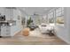 Open living room and kitchen area with hardwood floors and large windows at 2513 Rochelle St, Durham, NC 27703