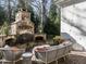 Backyard featuring a stone fireplace, outdoor seating, and a well-maintained brick patio at 2900 Glenanneve Pl, Raleigh, NC 27608