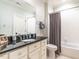 Clean bathroom featuring a black countertop vanity and a shower with a gray curtain at 2900 Glenanneve Pl, Raleigh, NC 27608