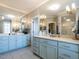 Spacious bathroom featuring dual sinks, vanity, shower, and abundant lighting at 2900 Glenanneve Pl, Raleigh, NC 27608