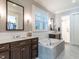 Luxurious bathroom with a soaking tub, double vanities, and a separate shower for a relaxing experience at 2900 Glenanneve Pl, Raleigh, NC 27608