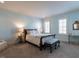 Serene bedroom with light blue walls, a comfortable bed, and ample natural light from the shuttered windows at 2900 Glenanneve Pl, Raleigh, NC 27608