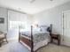 Cozy bedroom featuring a four-poster bed with blue and white patterned bedding and ample natural light at 2900 Glenanneve Pl, Raleigh, NC 27608