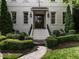 Charming home entrance featuring a decorative door, manicured bushes, and an ornate stone walkway at 2900 Glenanneve Pl, Raleigh, NC 27608