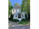 Stunning two-story white brick home with lush landscaping and a manicured lawn at 2900 Glenanneve Pl, Raleigh, NC 27608