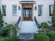 Close up of the front entrance showing a beautiful wood door, white stairs, and manicured landscaping at 2900 Glenanneve Pl, Raleigh, NC 27608