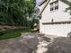 Exterior view of a clean, white two-car garage with an extended driveway, bordered by green lawn and trees at 2900 Glenanneve Pl, Raleigh, NC 27608