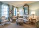Bright living room features designer window treatments, accent furniture, and a decorative gold mirror at 2900 Glenanneve Pl, Raleigh, NC 27608