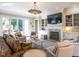 Spacious living room with built-in shelves, a fireplace, and a large TV at 2900 Glenanneve Pl, Raleigh, NC 27608