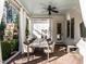 Outdoor dining area on a covered patio with white drapes and a view of the backyard fireplace at 2900 Glenanneve Pl, Raleigh, NC 27608