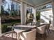Covered patio with an outdoor table, chairs, and a charming stone fireplace in the background at 2900 Glenanneve Pl, Raleigh, NC 27608