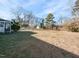 Large backyard with grassy area and shed in the distance at 301 King Arthur Trl, Garner, NC 27529