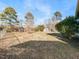 Spacious backyard with grassy area and mature trees at 301 King Arthur Trl, Garner, NC 27529