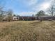 Large backyard with grassy area and partial view of house at 301 King Arthur Trl, Garner, NC 27529