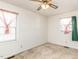 Bright bedroom with neutral walls, ceiling fan, and two windows at 301 King Arthur Trl, Garner, NC 27529